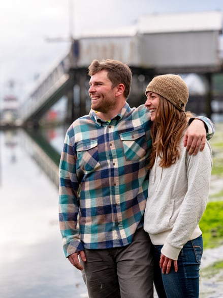 Two people on the shore smiling