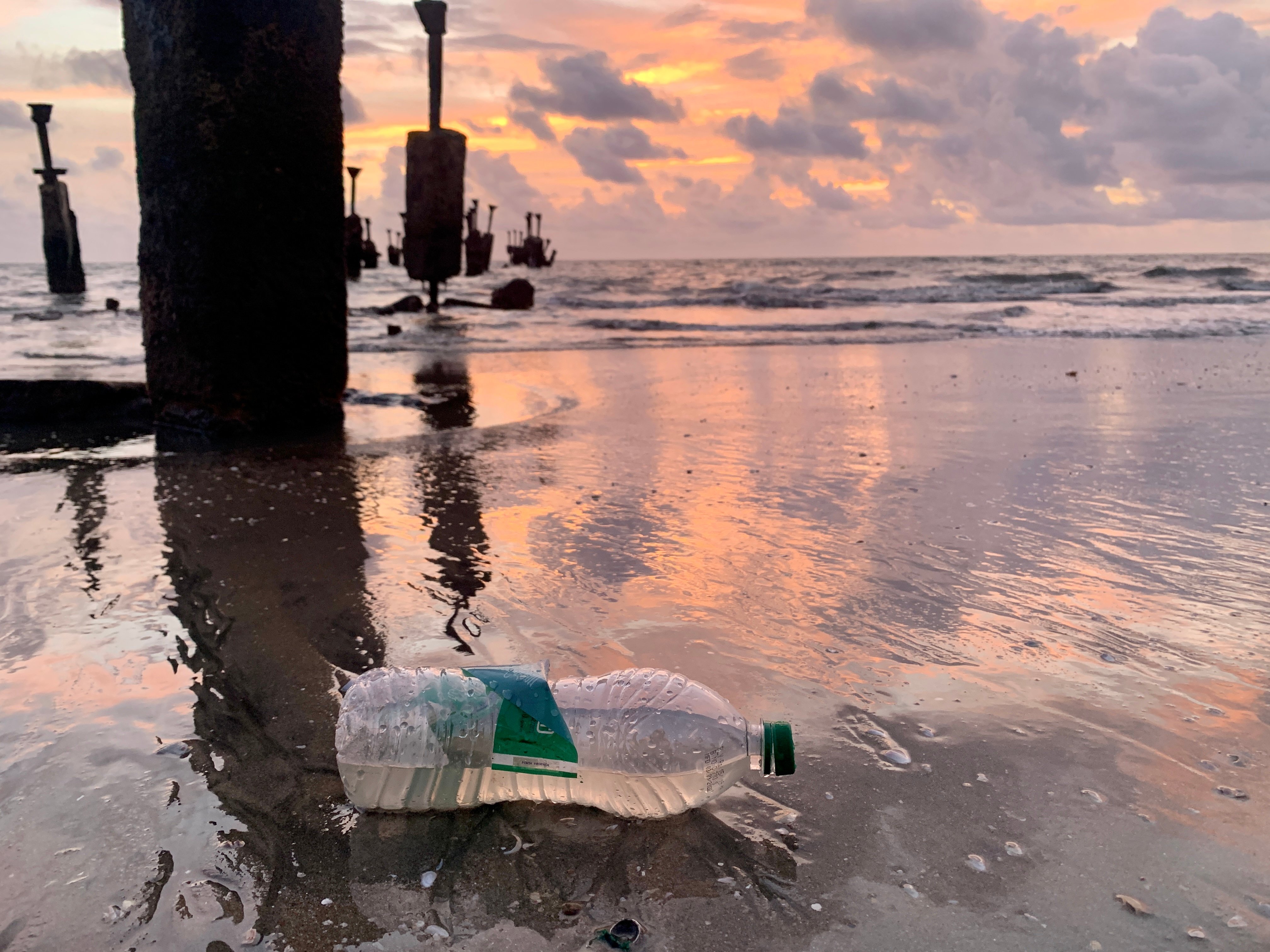 sunset with plastic on the beach